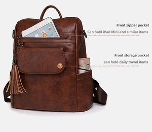 Detail view of large capacity vintage brown leather backpack with front zipper and side pockets