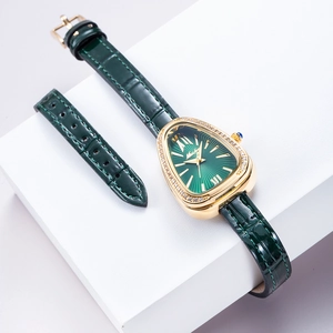 Detailed close-up of a golden snake-head watch with green dial and leather strap