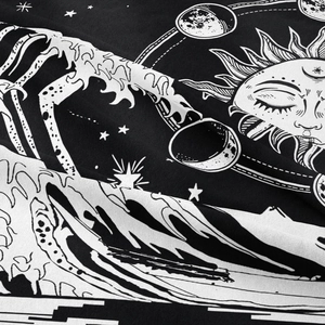 Close-up of soft black and white tapestry fabric with detailed tarot patterns and texture