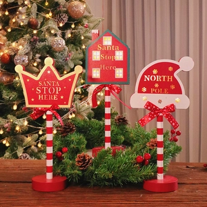 Three LED wooden Christmas STOP signs with red stripes and bows for holiday table decor
