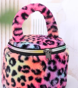 Detail showing the plush leopard print texture and metal zipper of the vanity case