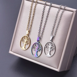 Detailed view of hollow Tree of Life pendants in gold, silver, and iridescent finishes