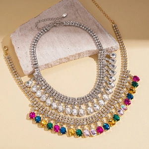 Elegant silver and multicolored crystal tassel long necklaces on grey stone base