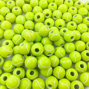 Macro view of neon green tennis ball acrylic beads with white curved lines and center holes