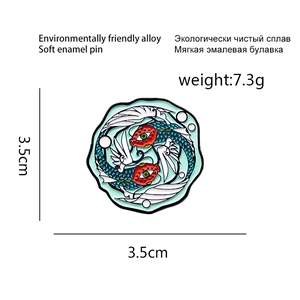 Artistic double fish enamel pin with yin yang design in blue and white colors