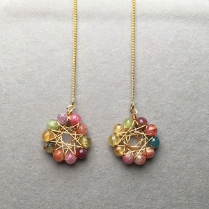 Macro shot of colorful tourmaline crystal beads with 14K gold-filled wire wrap detail