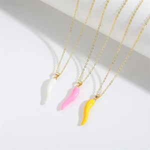 Minimalist chili pepper pendant necklaces in white, pink, and yellow with gold chains