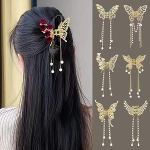 Golden butterfly hair claw clip with long pearl tassels and rhinestone details