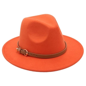 Detailed macro view of orange wool fedora hat with brown leather belt and gold buckle