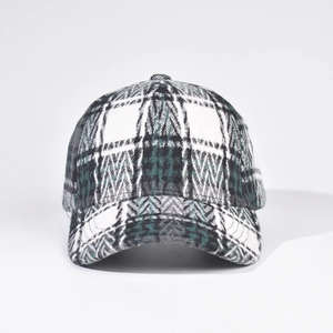 Detailed view of the thick wool blend plaid pattern on a winter baseball cap