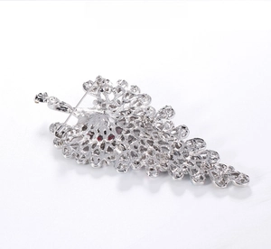 Detail of vintage peacock brooch back with hollow mesh pattern and safety pin closure