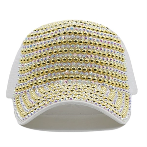 Detailed view of white baseball cap with gold beads and iridescent rhinestones