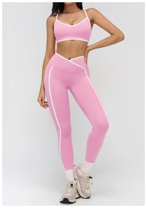 Detailed view of v-neck pink yoga sports bra with contrast white trim and high waist leggings