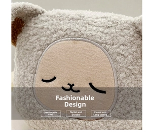 Close-up of soft faux shearling material with cute animal embroidery and plush texture
