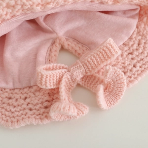 Pink knit baby girl hat with bow, featuring warm cotton lining and lace trim for outdoors