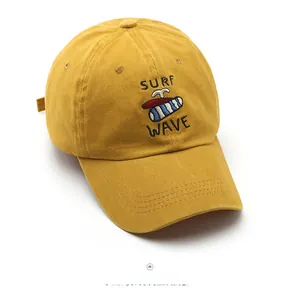 Detailed embroidery of Surf Wave and surfboard pattern on a yellow cotton baseball cap