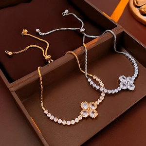 Adjustable zircon clover bracelets in gold and silver finish shown in a premium jewelry box