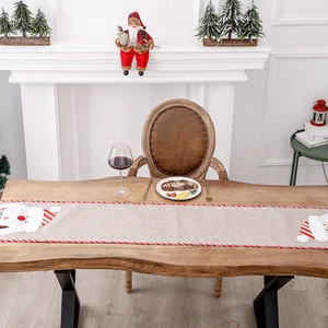Linen Christmas table runner with Santa Claus applique and festive red striped borders