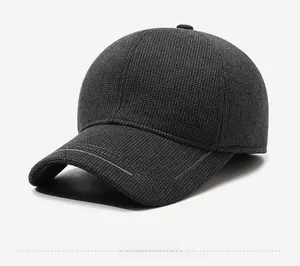 Detail of dark grey winter baseball cap featuring Nujia metal logo and Sport embroidery