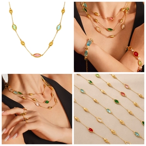 Detail of bohemian gold plated necklace set with colorful marquise cut glass stones