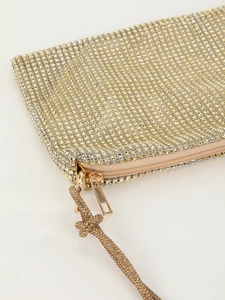 Close-up of sparkling rhinestone mesh clutch with high-quality metal zipper detail