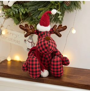 Detailed view of a buffalo plaid Christmas reindeer plush with festive holiday ornaments