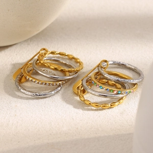 Close-up of 18K gold plated multi-layer safety pin ring with colorful cubic zirconia
