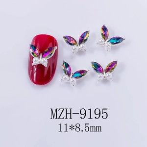 Detail view of 11x8.5mm aurora butterfly nail charms with rhinestones and white pearls