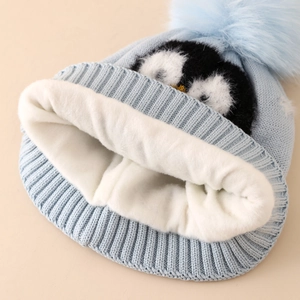 Blue winter knit hat for boys with fleece lining and cute penguin jacquard design