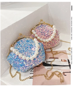 Detail of sequin shell bag with large pearl handle and vintage metal clasp closure