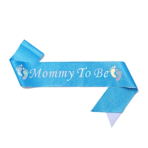 Detailed view of blue glitter Mommy To Be sash with holographic silver lettering
