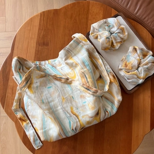 Artistic marble pattern cotton tote bag with matching scrunchies on a wooden table