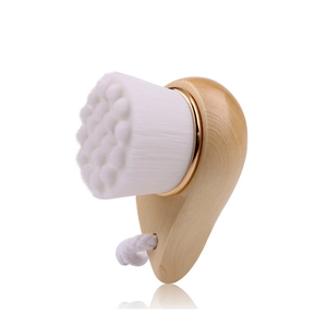 Close-up of soft fiber bristles and natural wooden handle facial cleansing brush