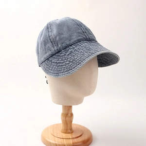 Detail view of the vintage washed denim baseball cap with reinforced stitched brim