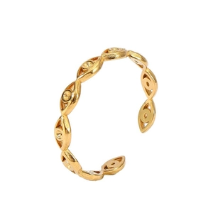 Detailed macro view of an 18k gold-plated open ring with evil eye relief elements