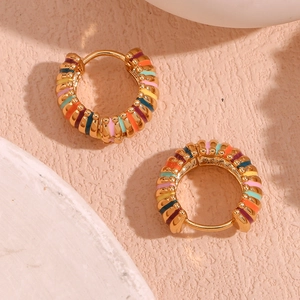 Close-up of gold-plated hoop earrings with vibrant colorful rainbow enamel stripes