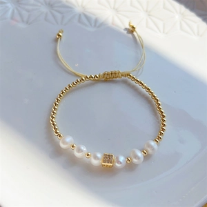 Vintage 18K gold plated bracelet with natural pearls and zircon on geometric ceramic tray