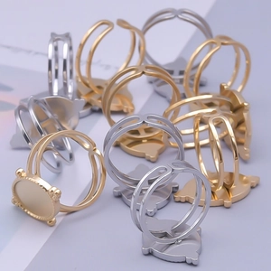 Macro shot of adjustable gold and silver ring bases with wavy edge for DIY jewelry making