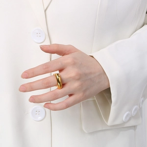 Close-up of polished 18k gold plated chunky square ring on model with white blazer