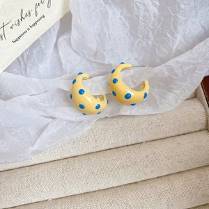 Chic yellow C-shaped earrings with blue polka dots and silver needle posts for women