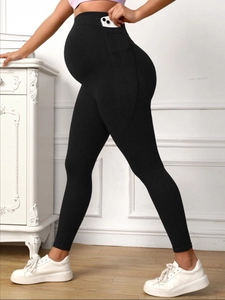 Detail of high waisted maternity yoga leggings with side pocket and belly support