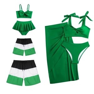 Family matching swimwear set in green featuring bikinis and striped swim trunks