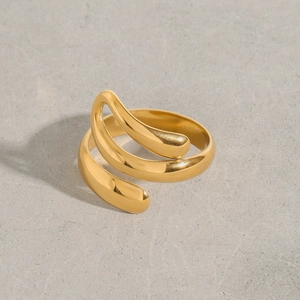 Macro detail of minimalist gold stainless steel ring with polished mirror finish surface