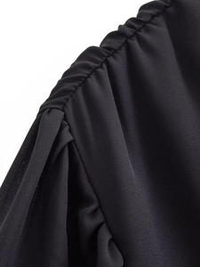 Macro shot of precise shirring and pleated details on the black chiffon shoulder fabric