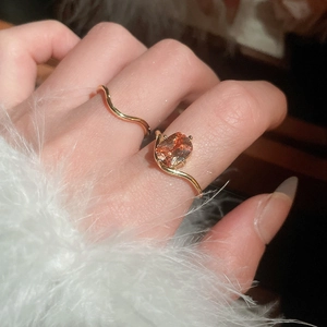 Detailed close-up of an 18k gold plated butterfly ring set with a vibrant orange zircon