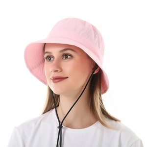 Detailed view of pink women's bucket hat with an adjustable black chin strap for wind