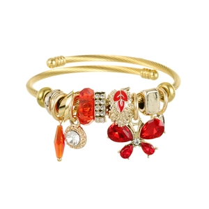 Gold stainless steel open bangle with butterfly charm and red crystal bead tassels
