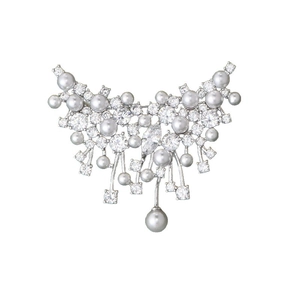 Elegant silver butterfly brooch with pearls and zircon crystals on a white background