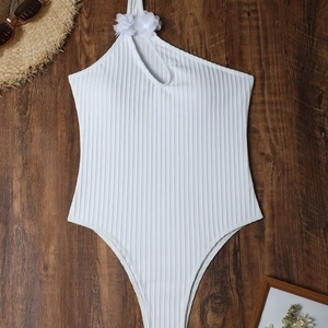 Detail of white ribbed one-piece swimsuit with floral shoulder accent and cutout