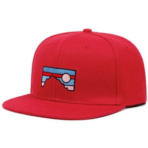 Close-up of red flat brim baseball cap featuring mountain embroidery patch and cotton texture